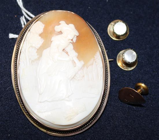 A gold mounted cameo brooch, two gold studs and one other stud,